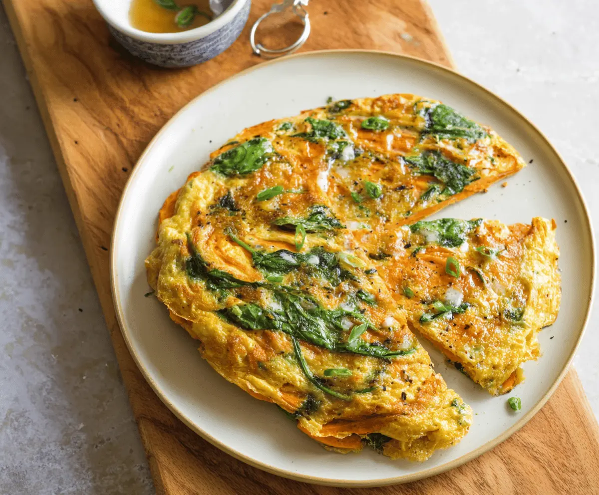 Delicious sweet potato and spinach omelette served on a plate, healthy breakfast idea with fresh ingredients