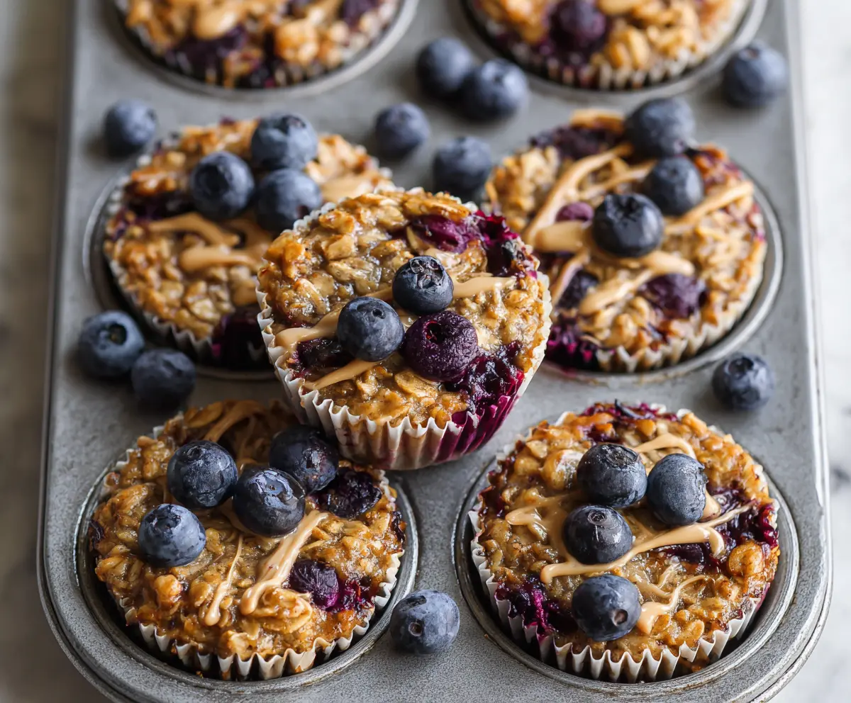 Delicious blueberry and banana baked oatmeal cups topped with fresh blueberries and slices of banana