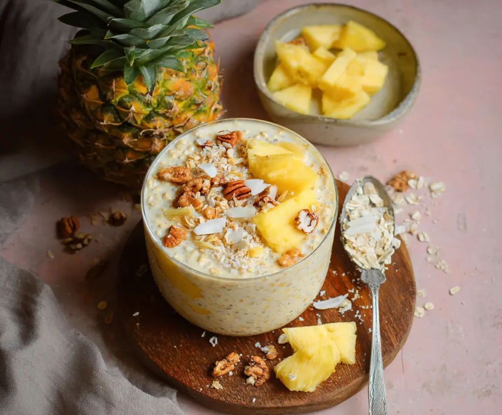 Creamy pineapple overnight oats topped with fresh pineapple chunks and chia seeds for a healthy breakfast.