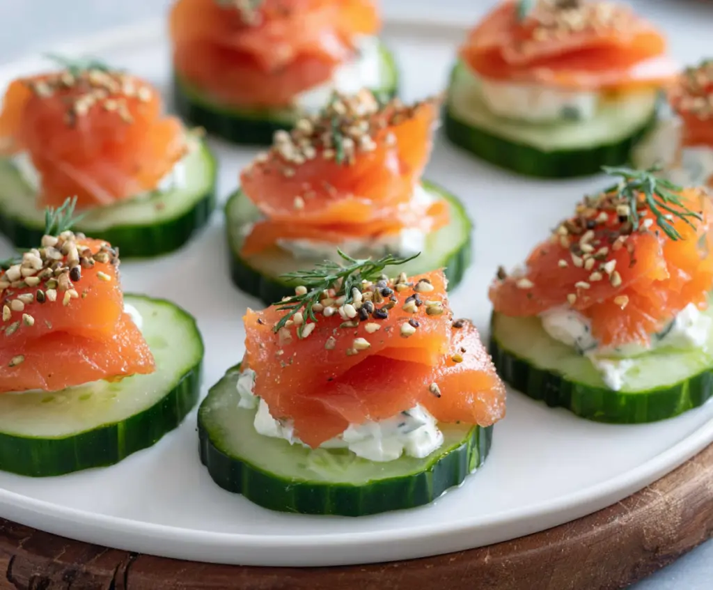 Delicious smoked salmon cucumber bites served on a platter, perfect for appetizers and parties.