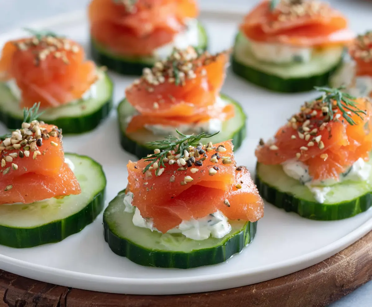 Delicious smoked salmon cucumber bites served on a platter, perfect for appetizers and parties.