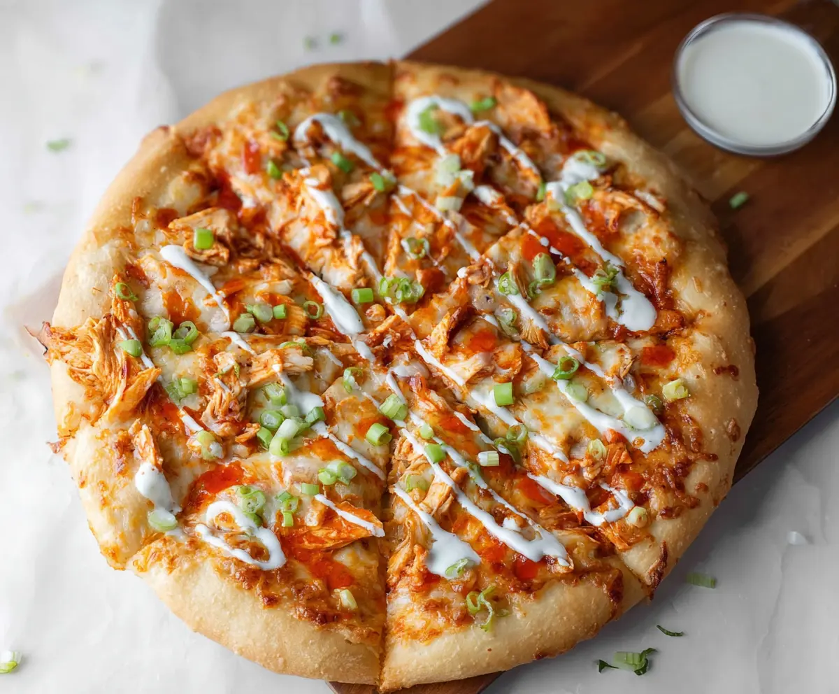 Delicious Buffalo Chicken Pizza topped with spicy sauce, cheese, and tender chicken slices.