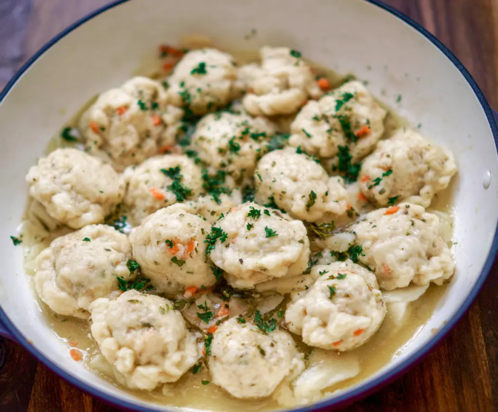 Golden sourdough discard dumplings served on a rustic plate, perfect for sharing.