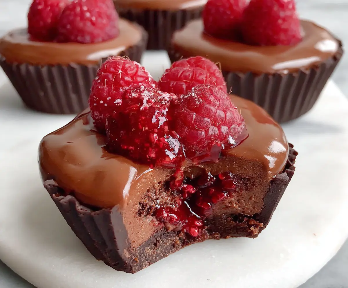 Delicious Marry Me Raspberry Chocolate Mousse Cups garnished with fresh raspberries and mint, perfect for romantic celebrations.