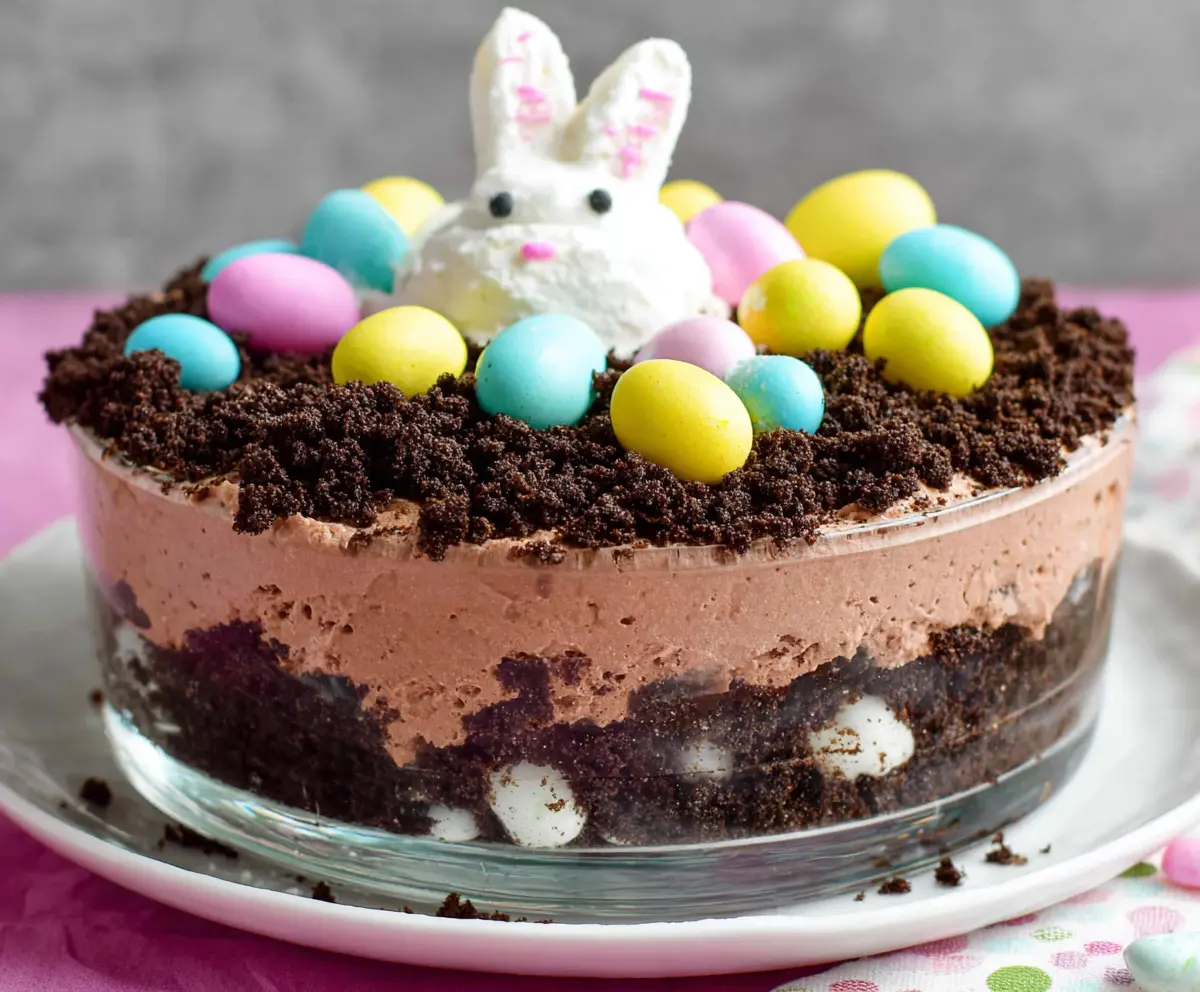 Delicious Easter Dirt Cake with chocolate pudding, crushed cookies, and colorful candy decorations
