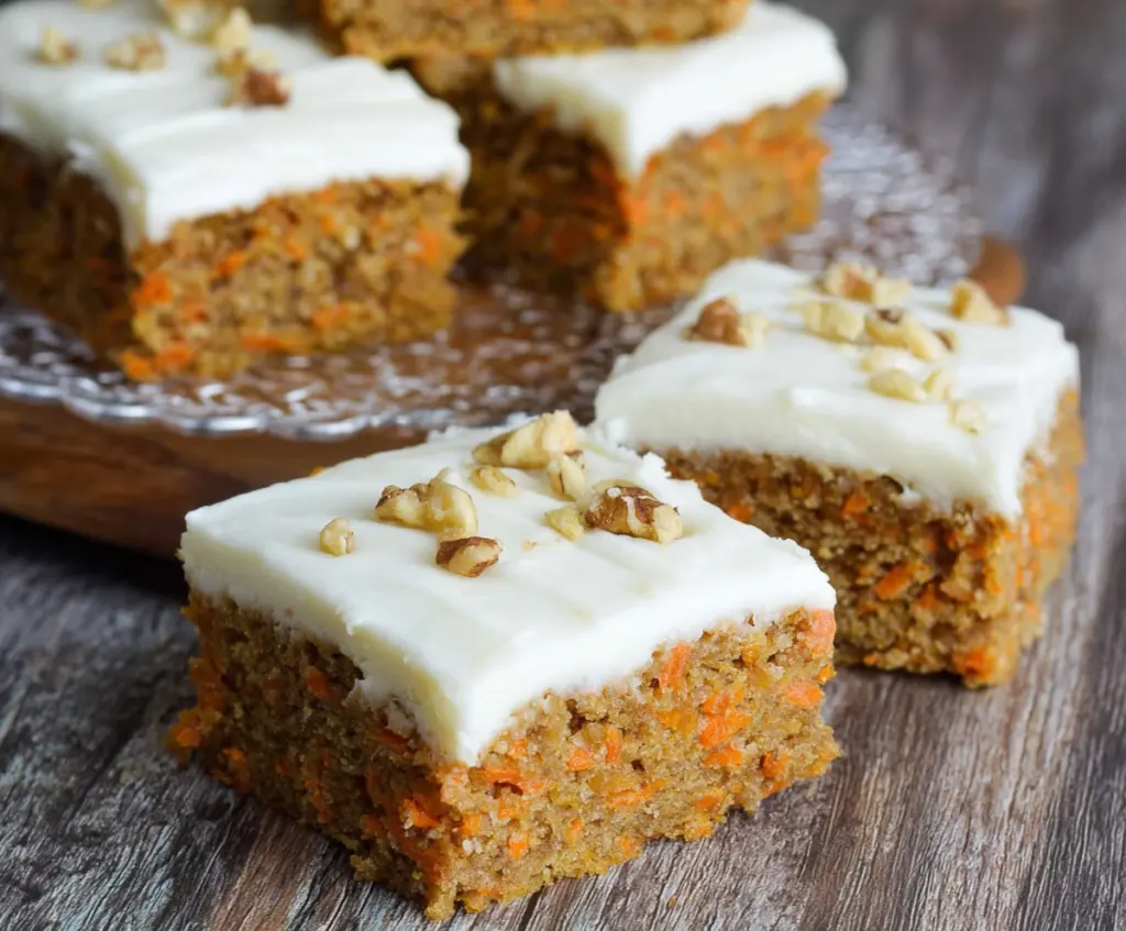 Delicious homemade carrot cake bars topped with creamy cream cheese frosting, perfect for dessert or snack time.